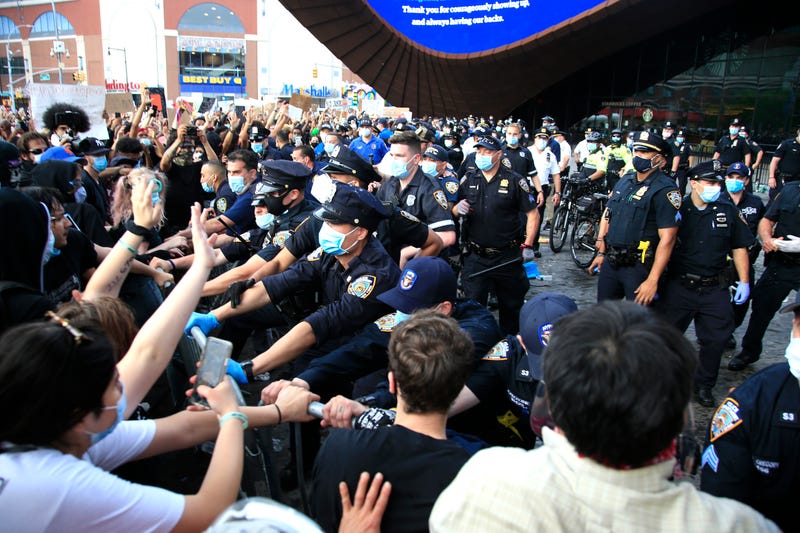 New York Police Department (NYPD) officers gather as activists hold a rally in response to the police killing George Floyd in front of Barclays Center on May 29, 2020 in the Brooklyn borough of New York City. Brooklyn joined nationwide protests following the police killing of George Floyd on May 25. Four Minneapolis police officers have been fired after a video taken by a bystander was posted on social media showing Floyd's neck being pinned to the ground by an officer as he repeatedly said, "I can’t breathe". Floyd was later pronounced dead while in police custody after being transported to Hennepin County Medical Center.
