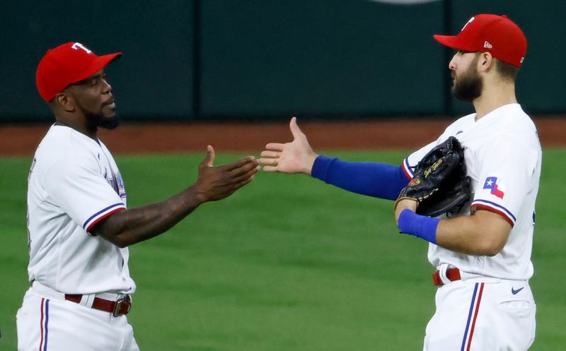 Adolis Garcia #53 of the Texas Rangers and teammate Joey Gallo #13 celebrate the teams 5-4 win over the Arizona Diamondbacks at Globe Life Field on July 27, 2021 in Arlington, Texas.