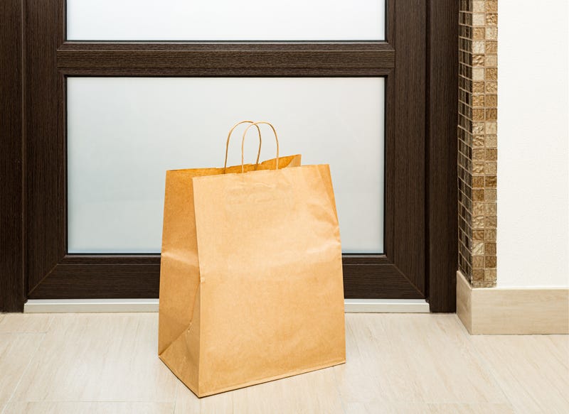 Paper bag near door of house.