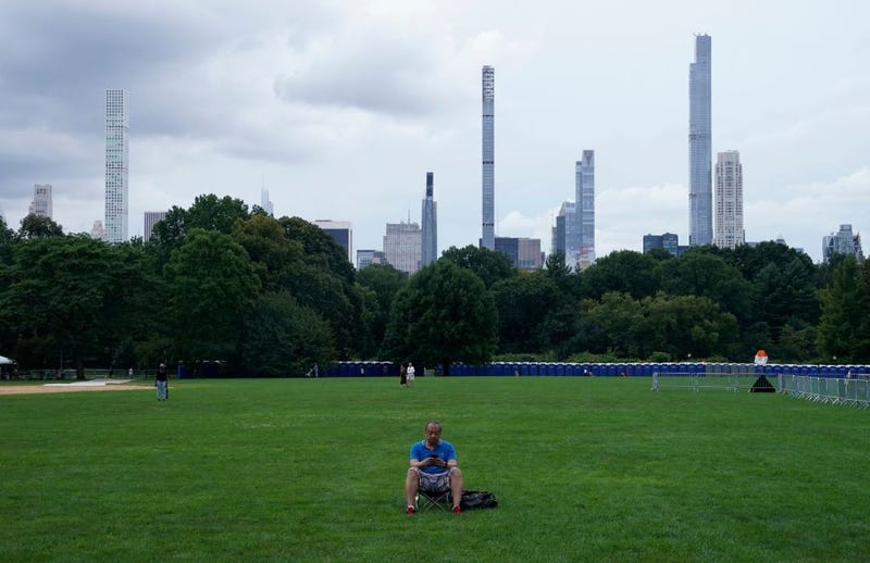 A man sits at Central Park's Great Lawn in New York on Aug. 20, 2021.