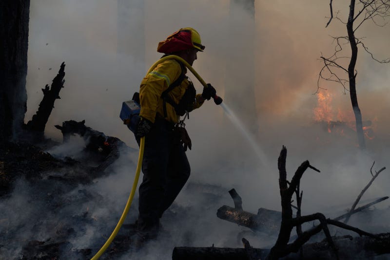 A wildfire hot shot crew defends property as the Dixie Fire pushes through the Genesee Valley on August 21, 2021 in Genesee, California