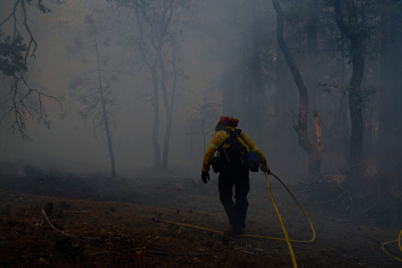 A wildfire hot shot crew defends property as the Dixie Fire pushes through the Genesee Valley on August 21, 2021 in Genesee, California