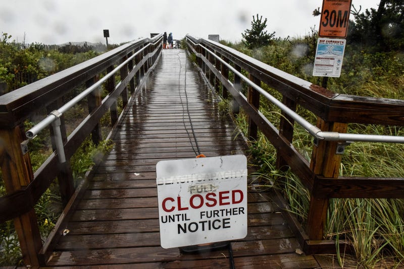 A sign announces the closure of the beach on August 22, 2021 in Montauk, New York. Tropical Storm Henri was downgraded from a Category 1 Hurricane on Sunday morning as heavy rain pounded the east end of Long Island.
