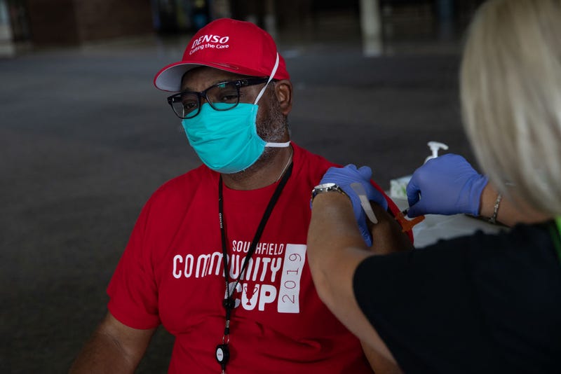 Anthony Faulkner receives his booster dose of the Moderna coronavirus (COVID-19) vaccine during an Oakland County Health Department vaccination clinic at the Southfield Pavilion on August 24, 2021 in Southfield, Michigan. Oakland County is the second county in Michigan to reach the state's goal of vaccinating 70% of its population. (Photo by Emily Elconin/Getty Images)