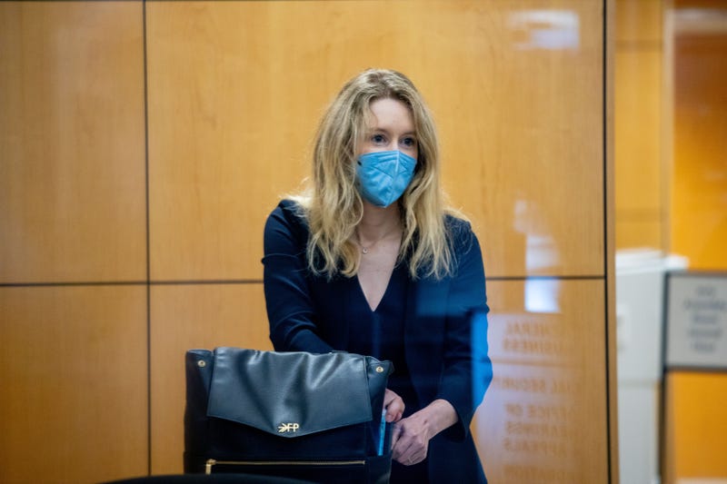 Theranos founder Elizabeth Holmes collects her belongings after going through security at the Robert F. Peckham Federal Building with her defense team on August 31, 2021 in San Jose, California.