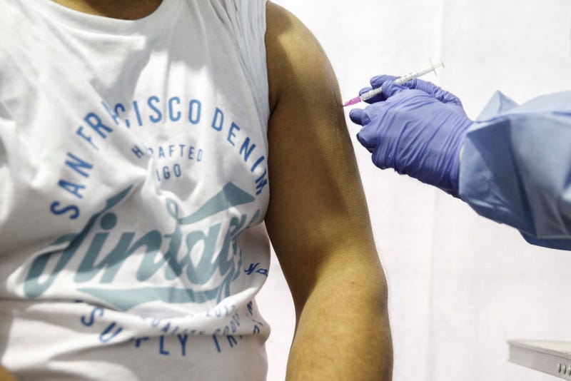 A man is given a dose of the Moderna vaccine in a temporary vaccination center in Berlin, Germany.