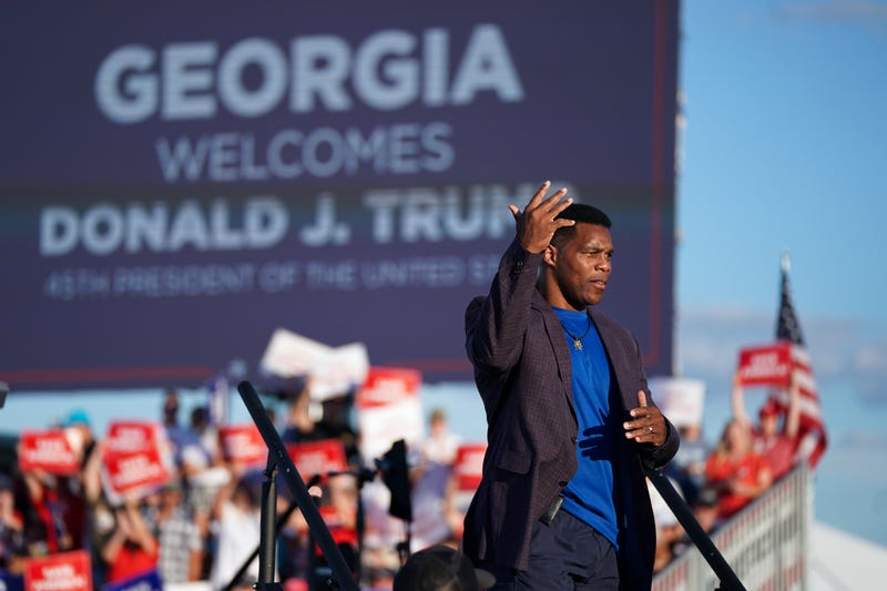 Republican Senate candidate Herschel Walker walks off the stage during a rally featuring former US President Donald Trump on September 25, 2021 in Perry, Georgia.