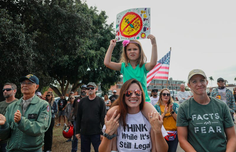 Anti-vaccine protesters stage a protest outside of the San Diego Unified School District office to protest a forced vaccination mandate for students on September 28, 2021, in San Diego, California.
