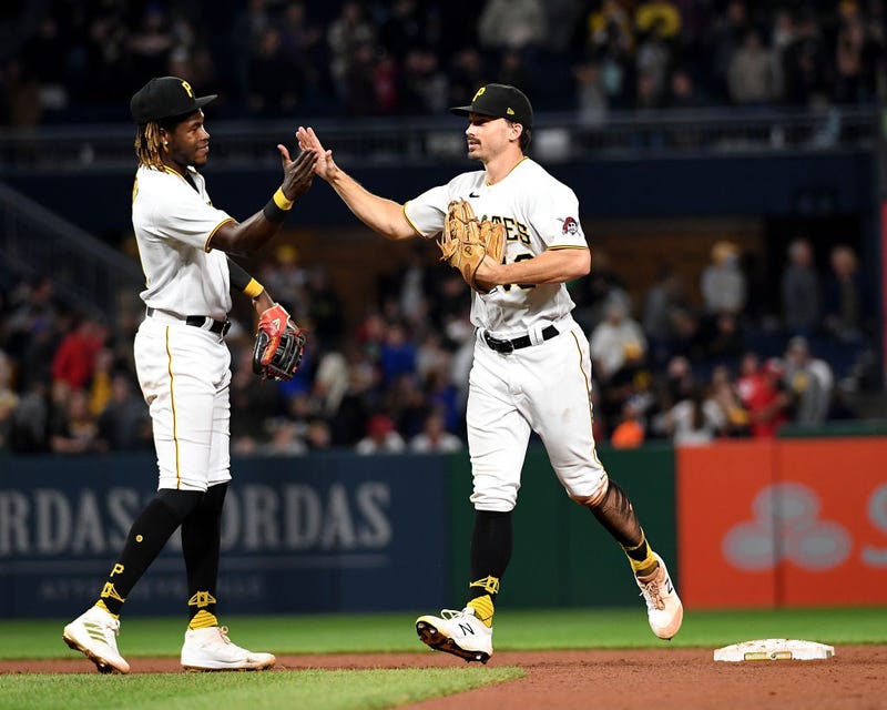 Oneil Cruz #61 of the Pittsburgh Pirates celebrates with Bryan Reynolds #10