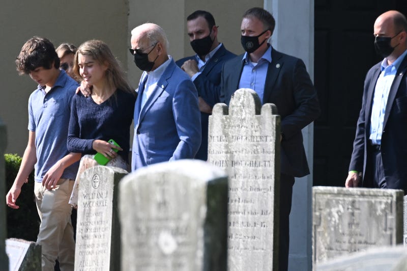 US President Joe Biden walks with his grandchildren Natalie and Hunter in Wilmington, Delaware, on October 3, 2021, after leaving St. Joseph on the Brandywine church.