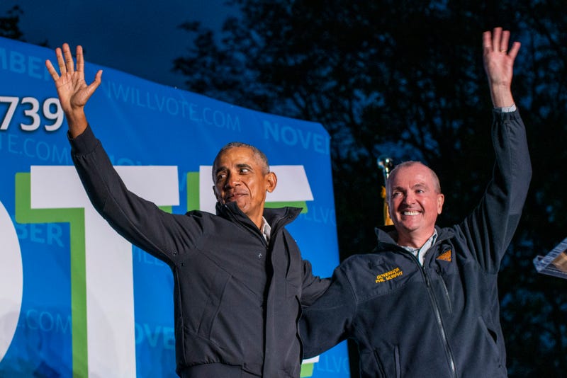 Former U.S. President Barack Obama (L) and New Jersey Governor Phil Governor Murphy wave at attendees after taking part in an early vote rally on October 23, 2021 in Newark, New Jersey.