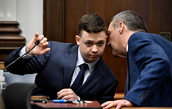Kyle Rittenhouse, left, listens to his attorney, Mark Richards.