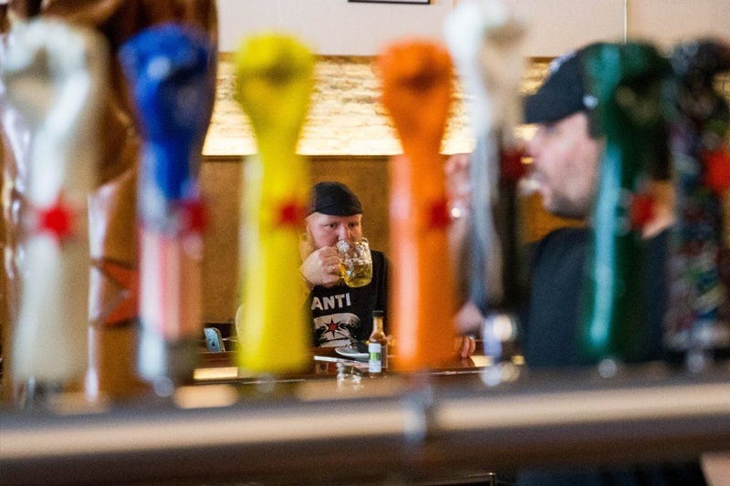 Aaron Keefner takes a sip of his beer at Revolution Brewing