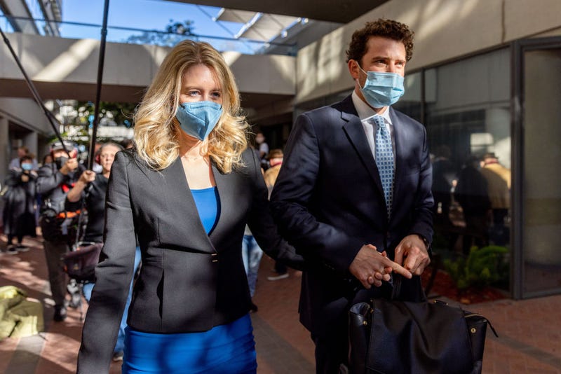 Theranos founder and former CEO Elizabeth Holmes along with her partner Billy Evans (R) depart the Robert F. Peckham Federal Building on November 22, 2021 in San Jose, California.