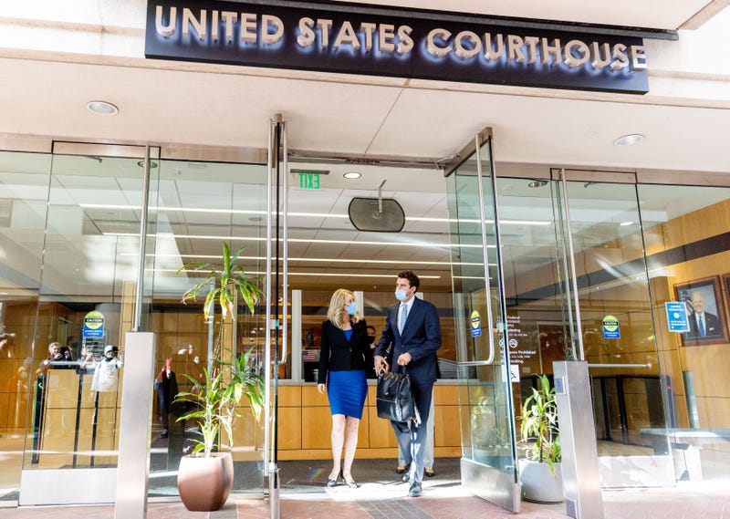 Theranos founder and former CEO Elizabeth Holmes along with her partner Billy Evans (R) depart the Robert F. Peckham Federal Building on November 22, 2021 in San Jose, California.