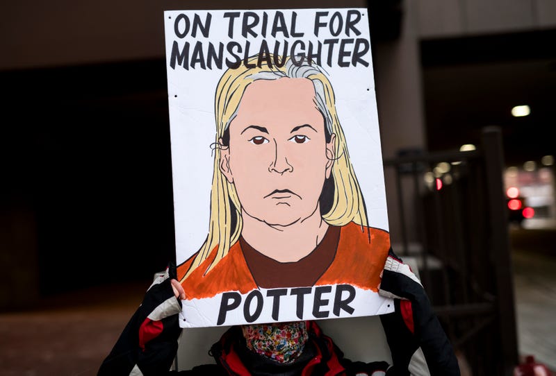 A person holds a sign as they demonstrate outside the Hennepin County Government Center on December 23, 2021 in Minneapolis, Minnesota. Jury deliberations are ongoing in the trial of former Brooklyn Center police officer Kim Potter, who is charged with manslaughter in the April 2021 shooting death of Daunte Wright. Potter says she thought she was using her Taser when she shot Wright with her handgun.
