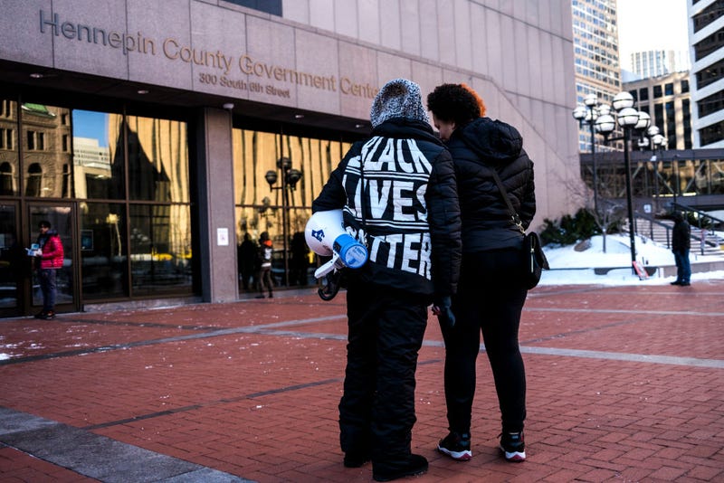 Diamond Wright (R), sister of Daunte Wright, speaks with activist Tanya James, outside the Hennepin County Government Center on December 23, 2021 in Minneapolis, Minnesota.
