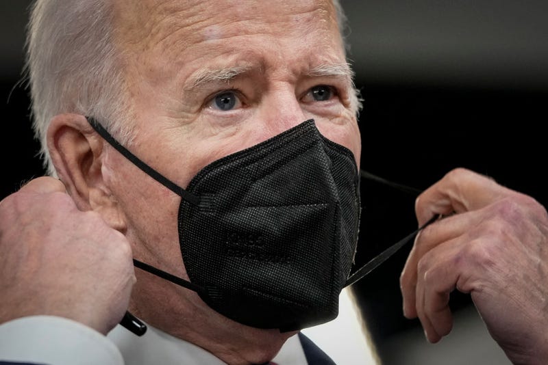 U.S. President Joe Biden removes his face mask as he arrives to sign H.R. 3537, the Accelerating Access to Critical Therapies for ALS Act in the South Court Auditorium of the White House complex December 23, 2021 in Washington, DC.