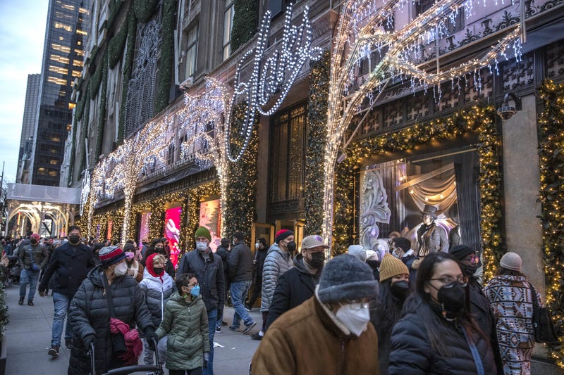 Shoppers walk past Saks Fifth Avenue in Manhattan in December 2021