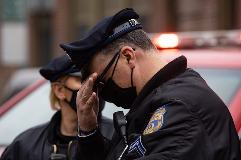 Police react near the scene of a fire that killed 13 people, including seven children, in Philadelphia's Fairmount neighborhood on Jan. 5, 2022.
