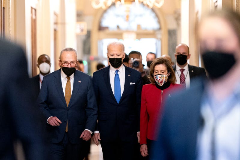 U.S. President Joe Biden, center, joined by Senate Majority Leader Chuck Schumer, (D-NY), left, and U.S. House Speaker Nancy Pelosi (D-CA), walks through the Hall of Columns