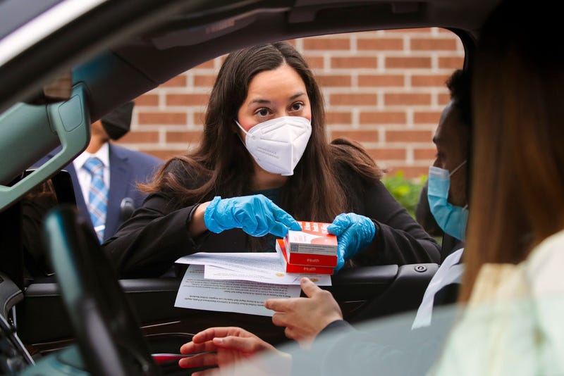 LAUSD Board President Kelly Gonez distributes in-home COVID test kits free from Los Angeles Unified School District at Johnnie L. Cochran Jr. Middle School on Friday, Jan. 7, 2022, in Los Angeles.