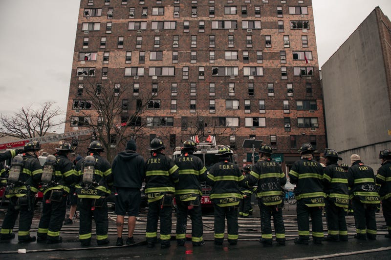 Emergency first responders outside a fire at the 19-story Twin Parks North West tower on Jan. 9, 2022
