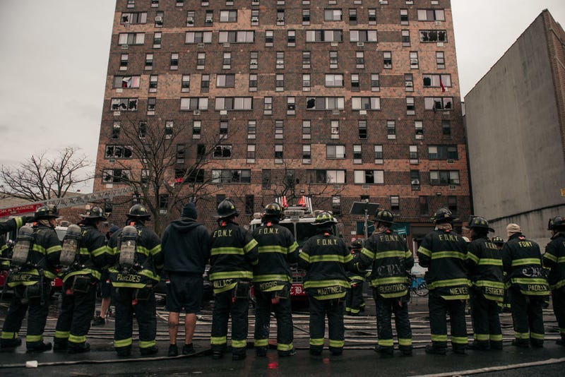 Emergency first responders remain at the scene after an intense fire at a 19-story residential building that erupted on Jan. 9, 2022
