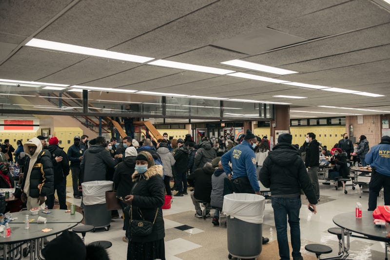 Residents take refuge at a school cafeteria after a fire erupted at their 19-story apartment building in the morning hours on Jan. 9, 2022 in the Bronx