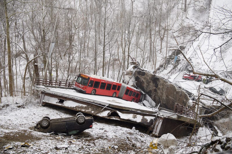 Vehicles including a Port Authority bus are left stranded after a bridge collapsed along Forbes Avenue on January 28, 2022 in Pittsburgh, Pennsylvania