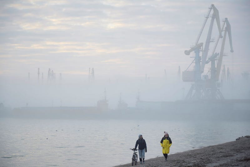 A couple walks on a beach near the port of Berdyansk on the Azov Sea on February 16, 2022 in Berdyansk, Ukraine.(Photo by Pierre Crom/Getty Images)