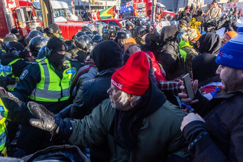 Protestors and the police face off in blockaded streets surrounding Parliament Hill on Feb. 18, 2022 in Ottawa, Ontario, Canada.