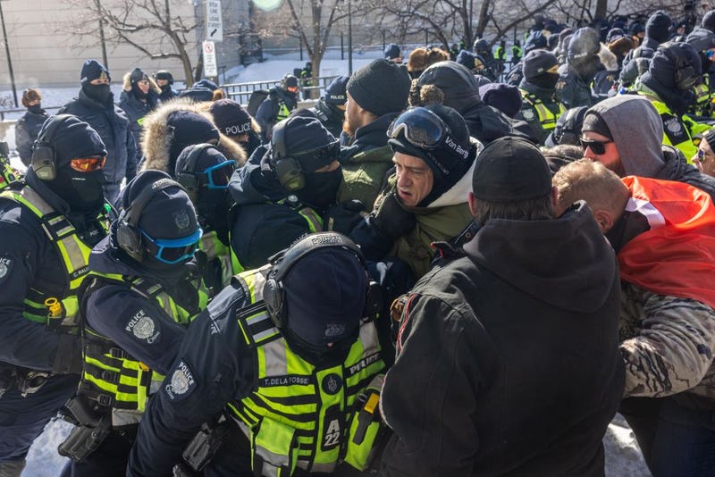 The police push protestors back on February 18, 2022 in Ottawa, Ontario, Canada. Demonstrators gathered to occupy the area surrounding Parliament Hill as a protest vaccine mandates and restrictions brought on by the spread of COVID-19.