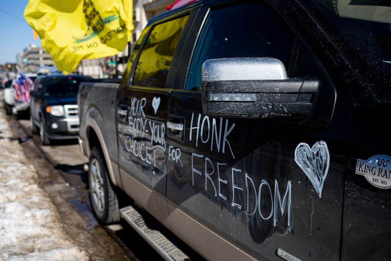 LANSING, MI - FEBRUARY 20: Cars line up to participate in a Freedom Convoy protesting Covid restrictions and demanding election audits on February 20, 2022 in Lansing, Michigan. The Freedom Convoy has been circling the Michigan State Capitol daily while simultaneously honking horns in support of ongoing protests in Canada. (Photo by Emily Elconin/Getty Images)