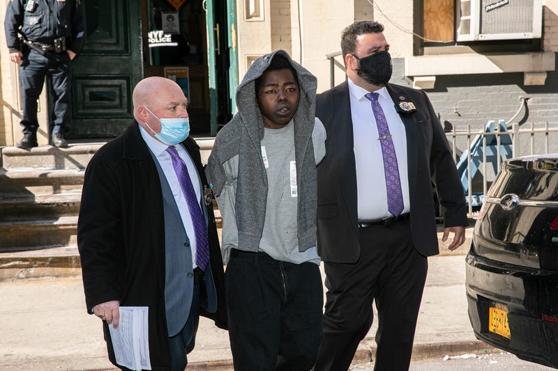 Assamad Nash, center, is escorted by police officers from the 5th Precinct in Manhattan on Feb. 14, 2022