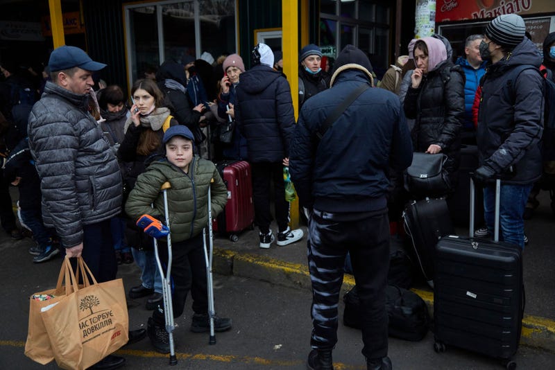 People wait for buses at a bus station as they attempt to evacuate the city on February 24, 2022 in Kyiv, Ukraine. Overnight, Russia began a large-scale attack on Ukraine, with explosions reported in multiple cities and far outside the restive eastern regions held by Russian-backed rebels.