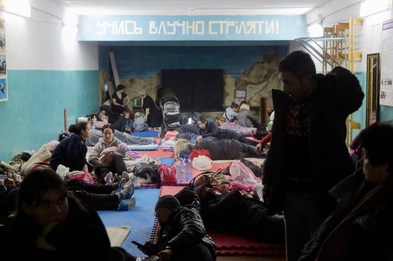 Hundreds of residents from a residential building damaged by a missile gather in a bomb shelter in the basement of a school on February 25, 2022 in Kyiv, Ukraine