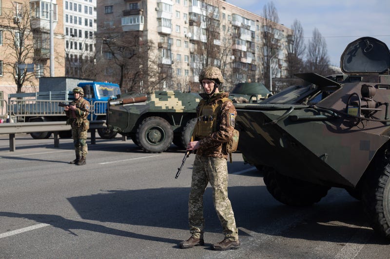 Ukrainian servicemen stand on patrol at a security checkpoint on February 25, 2022 in Kyiv, Ukraine