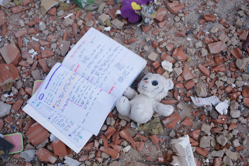 A toy and a note book lies among the debris by the apartment block in 6A Lobanovsky Avenue which was hit with a missile on February 26, 2022 in Kyiv, Ukraine. A residential building was hit as missile strikes were reported around Kyiv on the second night of Russia’s invasion of Ukraine, which has killed scores and prompted widespread condemnation from US and European leaders. (Photo by Anastasia Vlasova/Getty Images)