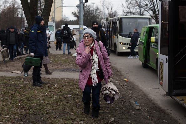 Residents of Irpin who evacuated wait to get seated in the buses to go further on March 6, 2022 in Kyiv, Ukraine.
