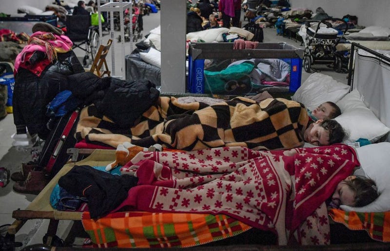 Children sleep in a temporary shelter for Ukrainian refugees in Poland