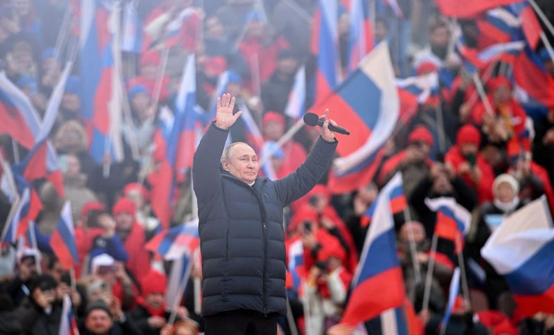  Russian President Vladimir Putin greets the audience as he attends a concert marking the eighth anniversary of Russia's annexation of Crimea at the Luzhniki stadium in Moscow on March 18, 2022