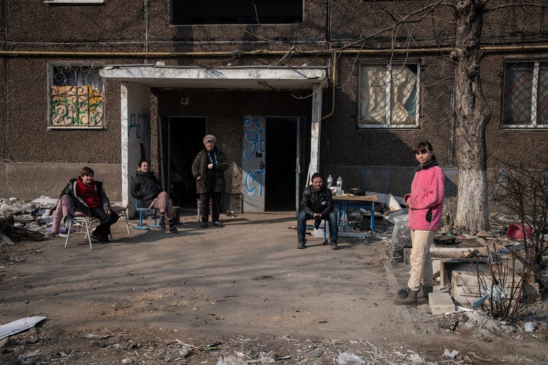 A family prepare to cook over an open fire outside their destroyed home in the embattled port city. The battle between Russian / Pro Russian forces and the defencing Ukrainian forces lead by Azov battalion continues in the port city of Mariupol
