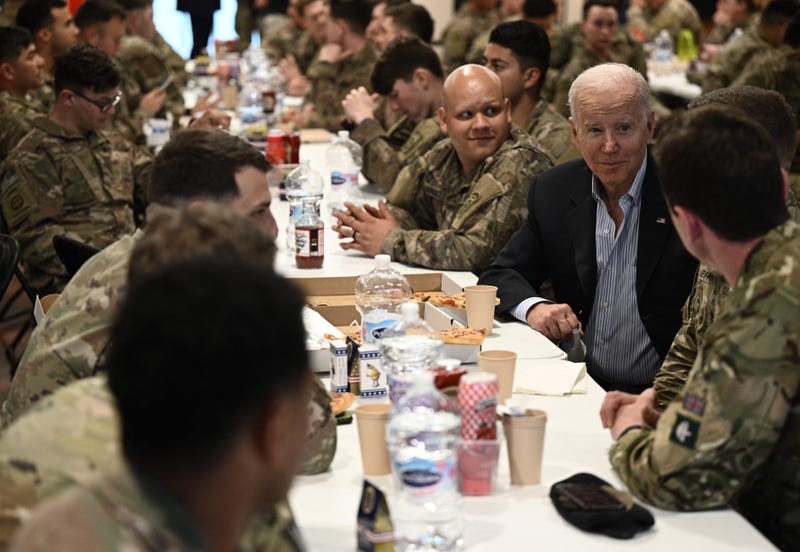 US President Joe Biden (R) meets service members from the 82nd Airborne Division, who are contributing alongside Polish Allies to deterrence on the Alliances Eastern Flank, in the city of Rzeszow in southeastern Poland, around 100 kilometres (62 miles) from the border with Ukraine, on March 25, 2022. 