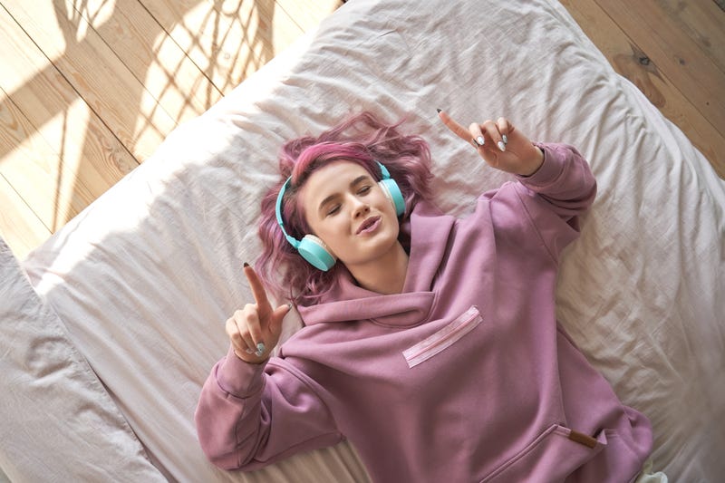 Teenager At Home Listening To Music
