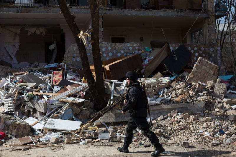 A police officer patrolls a residential area which was destroyed as a result of a rocket strike two weeks ago on March 28, 2022 in Kyiv, Ukraine. Ukraine's military says it has made territorial gains in the wider Kyiv region, after Russia's advance on the capital had largely stalled in recent weeks. But intermittent shelling and missile strikes persist