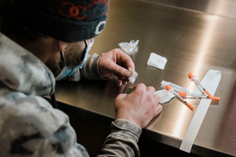 A man utilizes a narcotic consumption booth at a safe injection site in New York City.