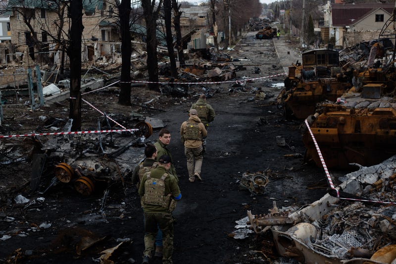 Ukrainian servicemen walk on the destroyed street on April 4, 2022 in Bucha, Ukraine