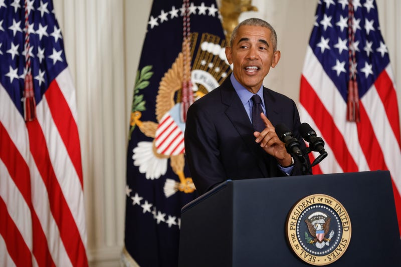 Former President Barack Obama speaking behind a podium