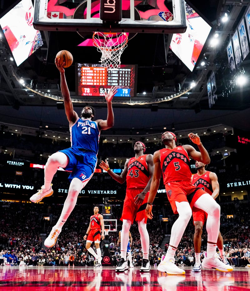 TORONTO, ON - APRIL 7: Joel Embiid #21 of the Philadelphia 76ers goes to the basket against Precious Achiuwa #5 and Pascal Siakam #43 of the Toronto Raptors during the second half of their basketball game at the Scotiabank Arena on April 7, 2022 in Toronto, Ontario, Canada. 